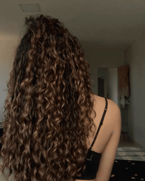 Achieve soft, bouncy curls with Bella Hararo’s Raw Indian Temple Hair Flat-Tip Natural Curly Extensions