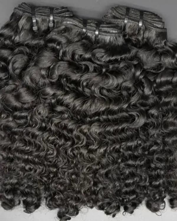 Unveil luxurious, voluminous curls with Premium Raw Indian Temple Wefted Hair in a stunning loose curly texture